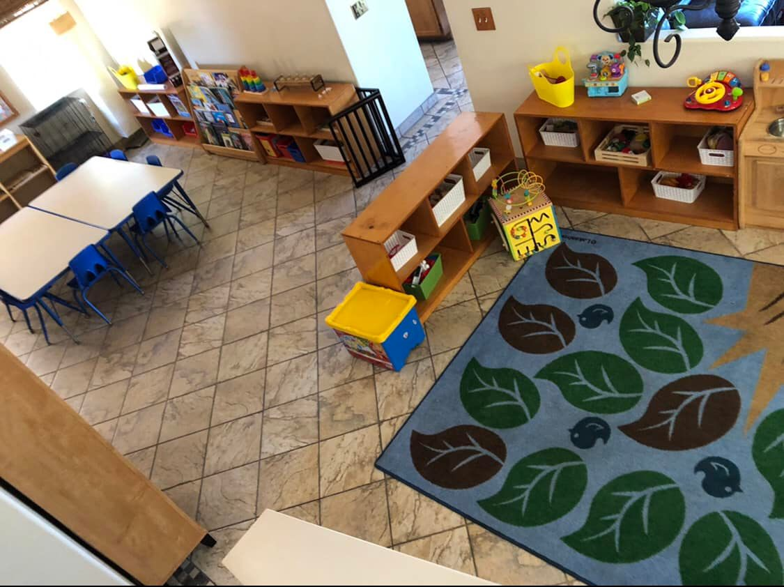 Indoor classroom with learning stations and play areas